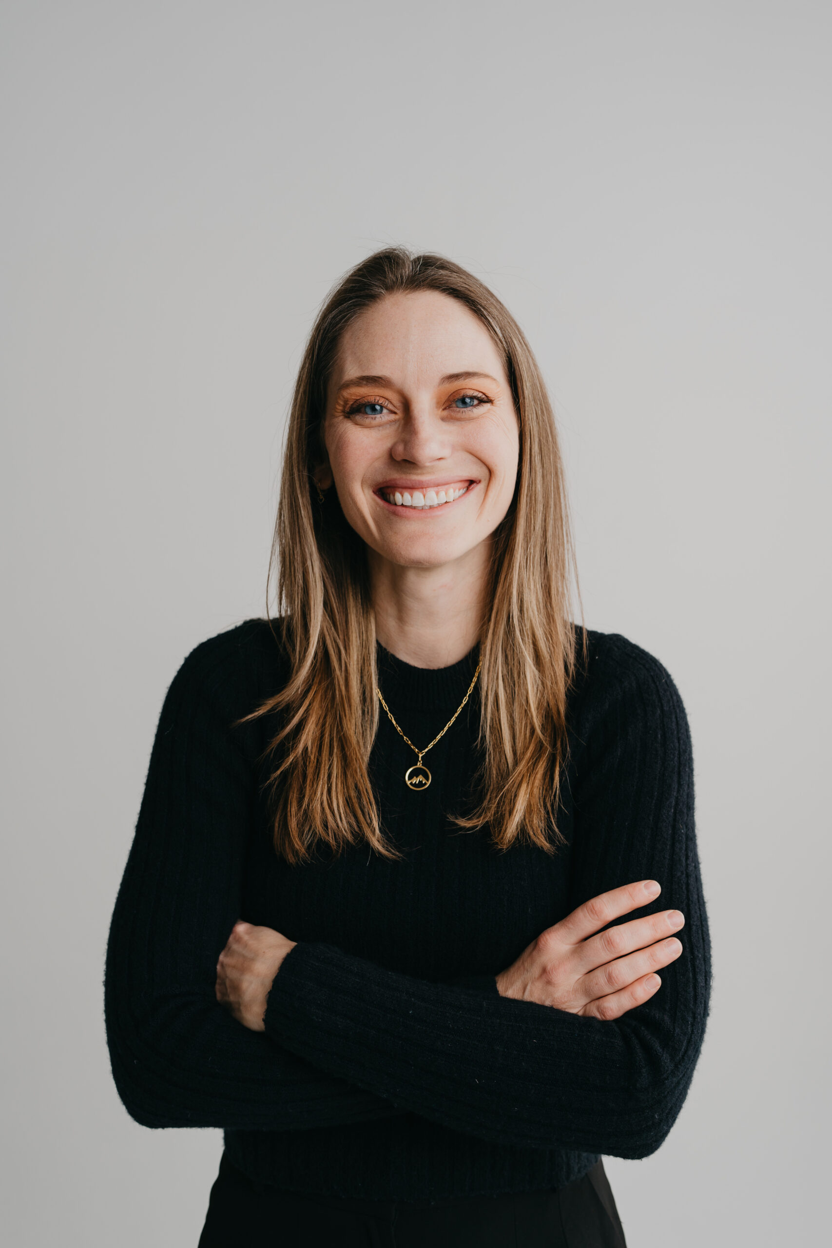 DJ Jen G, Jen in a black shirt with her arms crossed and a white background